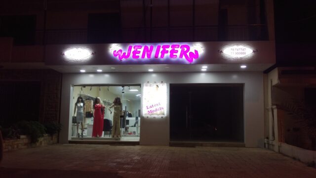 a store front with mannequins in the window