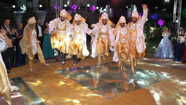 a group of men in clothing dancing