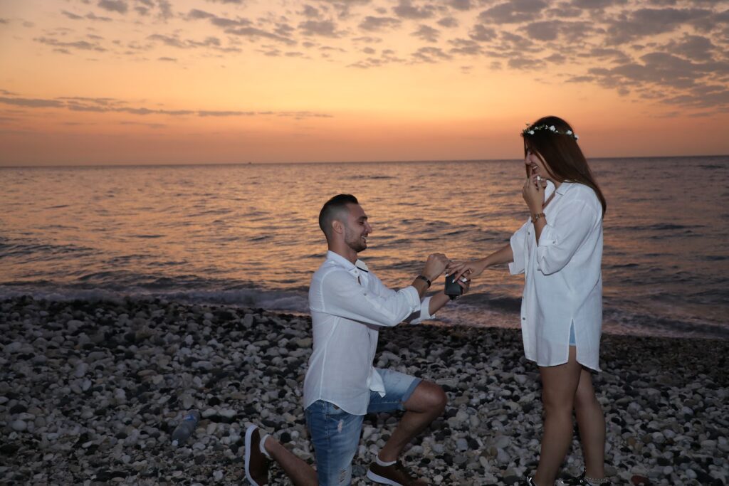 a man proposing to a woman on a beach