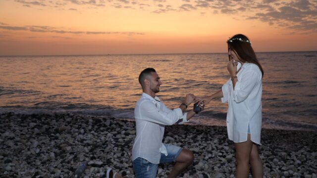 a man proposing to a woman on a beach