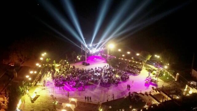 a group of people on a stage with lights