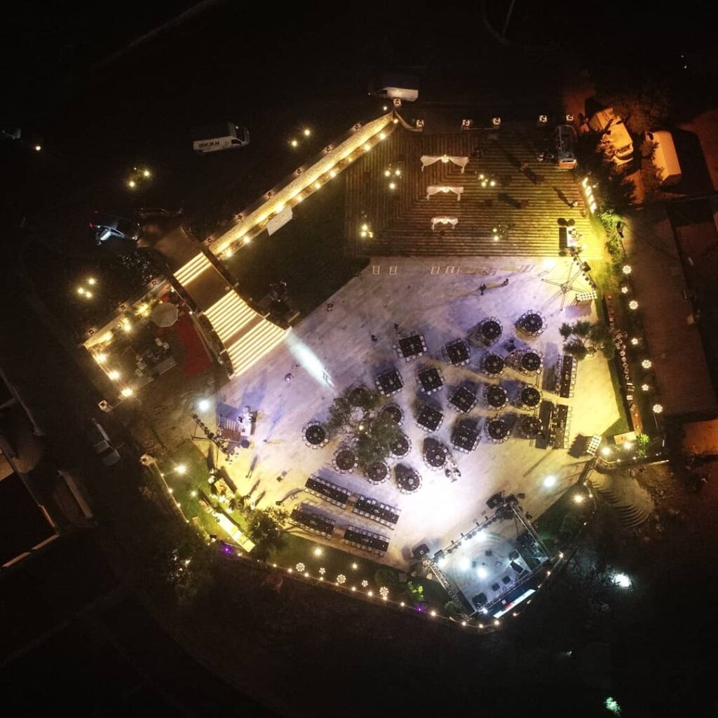 aerial view of a building with lights and cars