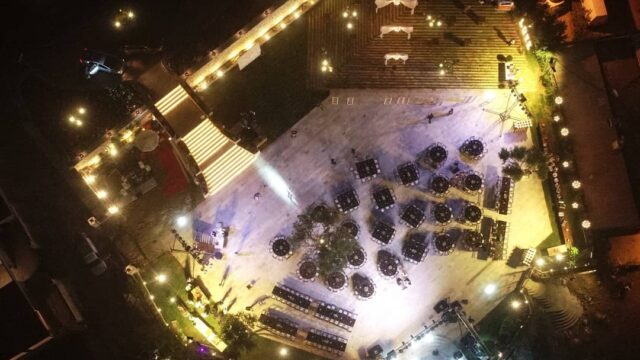 aerial view of a building with lights and cars