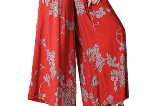 a woman wearing a red and grey floral pants