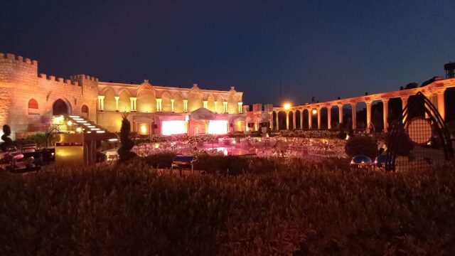 a building with a fountain and columns