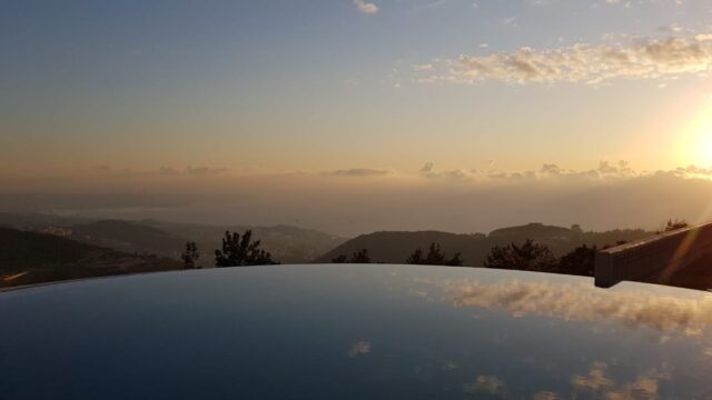 a view of a landscape from a pool