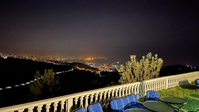 a table and chairs on a balcony overlooking a city