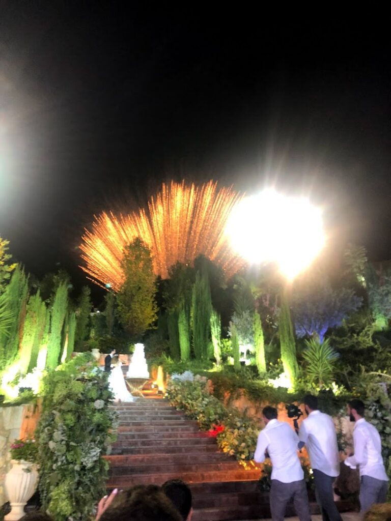 a group of people standing on stairs with fireworks in the background