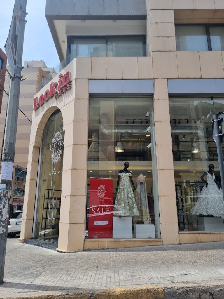 a store front with mannequins in a dress