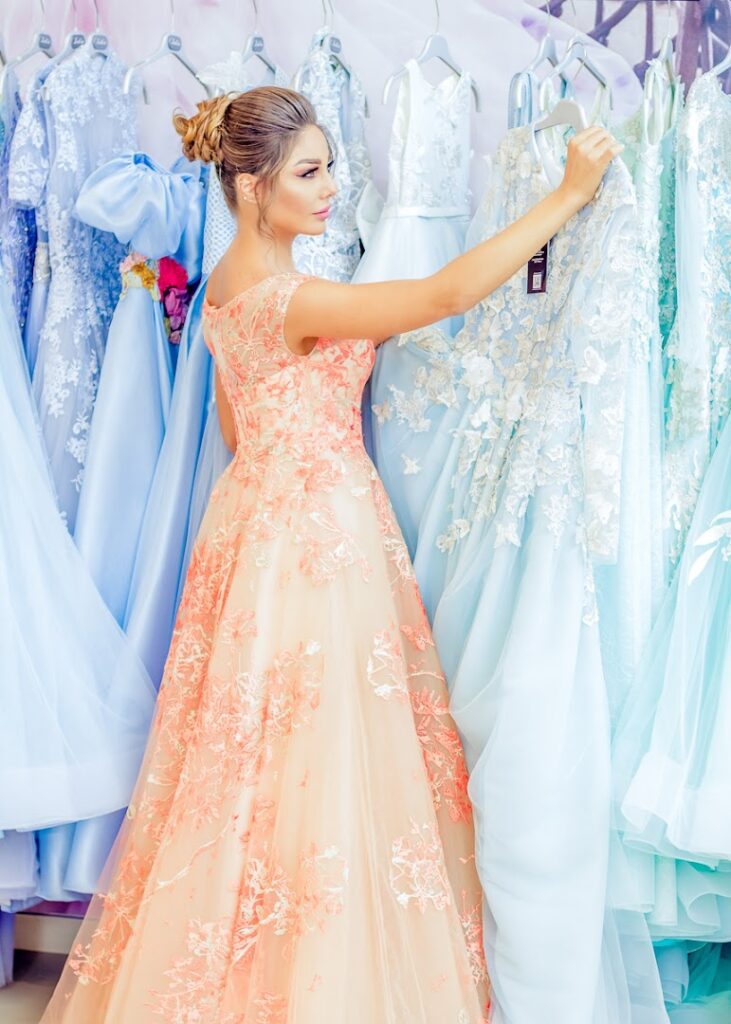 a woman in a dress looking at dresses