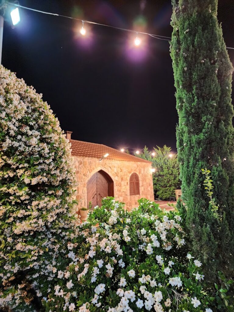 L'OR Wedding Venue is a building with trees and flowers.