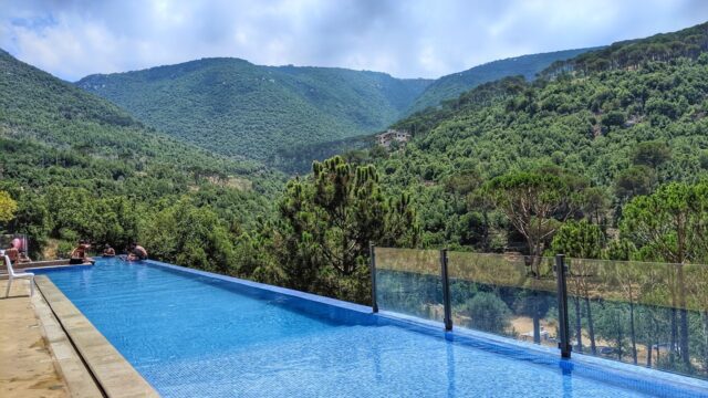 a pool with a view of the mountains