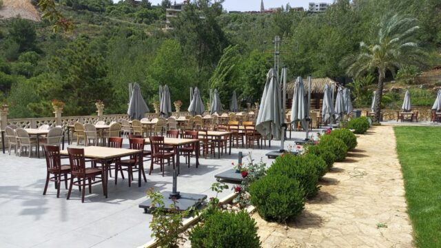 a patio with tables and chairs and umbrellas