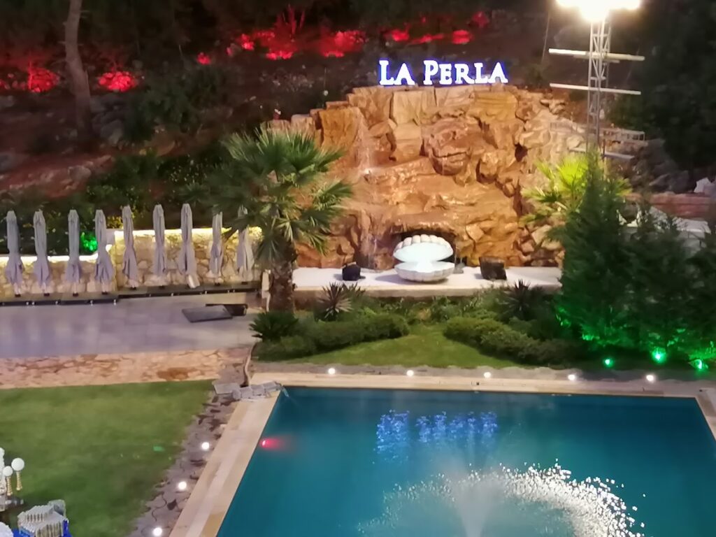 a pool with a fountain and a fountain in the middle