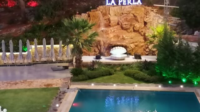 a pool with a fountain and a fountain in the middle