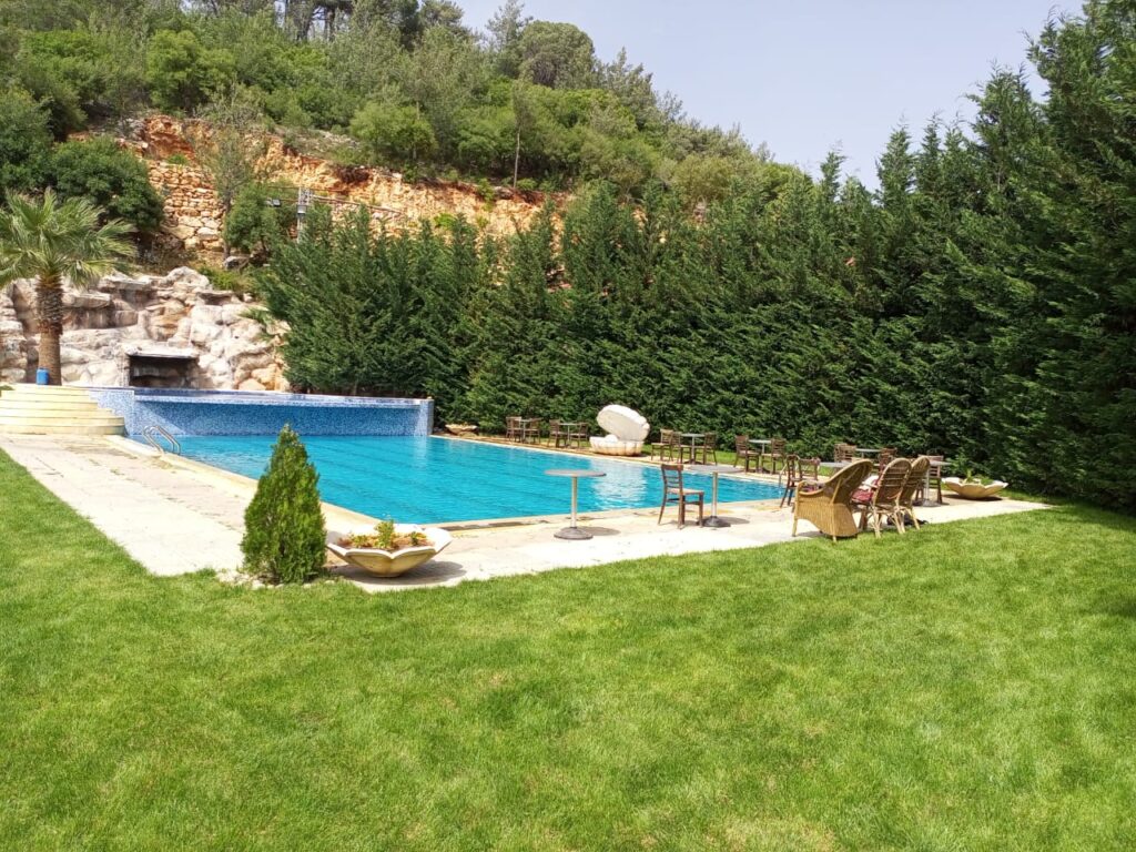 a pool with chairs and a lawn