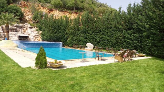 a pool with chairs and a lawn