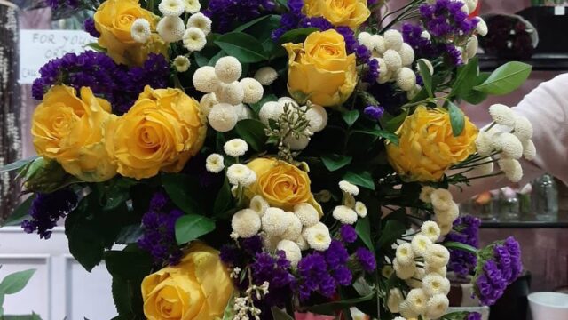 a bouquet of yellow and purple flowers