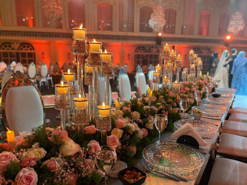 a table with flowers and candles