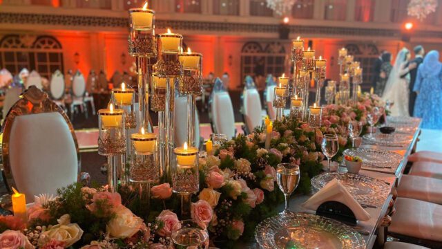 a table with flowers and candles