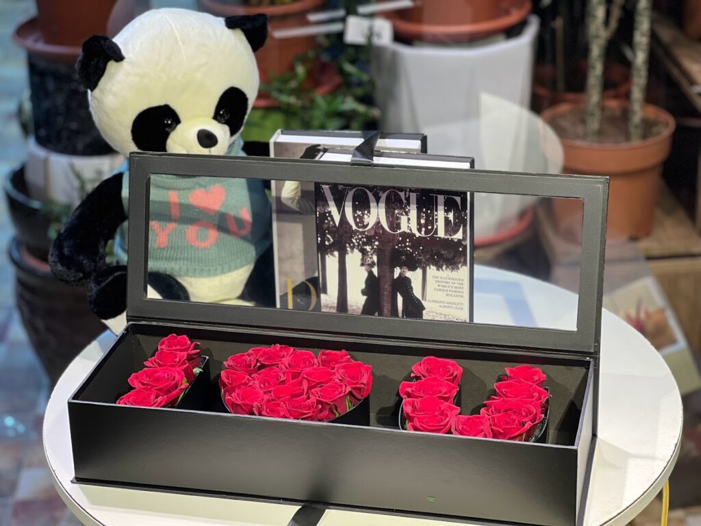 a box of roses and a stuffed panda