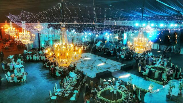 a large room with chandeliers and tables