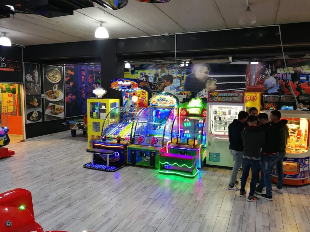 a group of people standing in front of a game machine