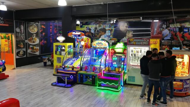 a group of people standing in front of a game machine