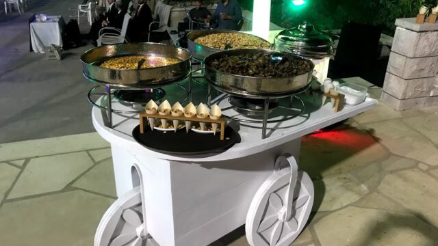 food on a cart with people sitting around