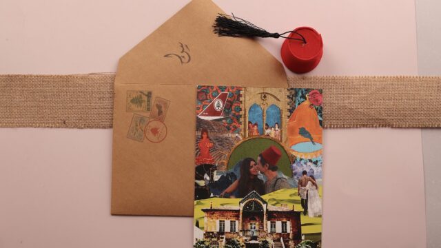 a card and a cap on a brown envelope