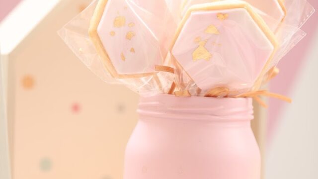 a pink jar with cookies in it