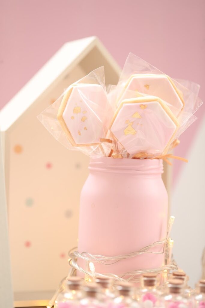 a pink jar with cookies in it