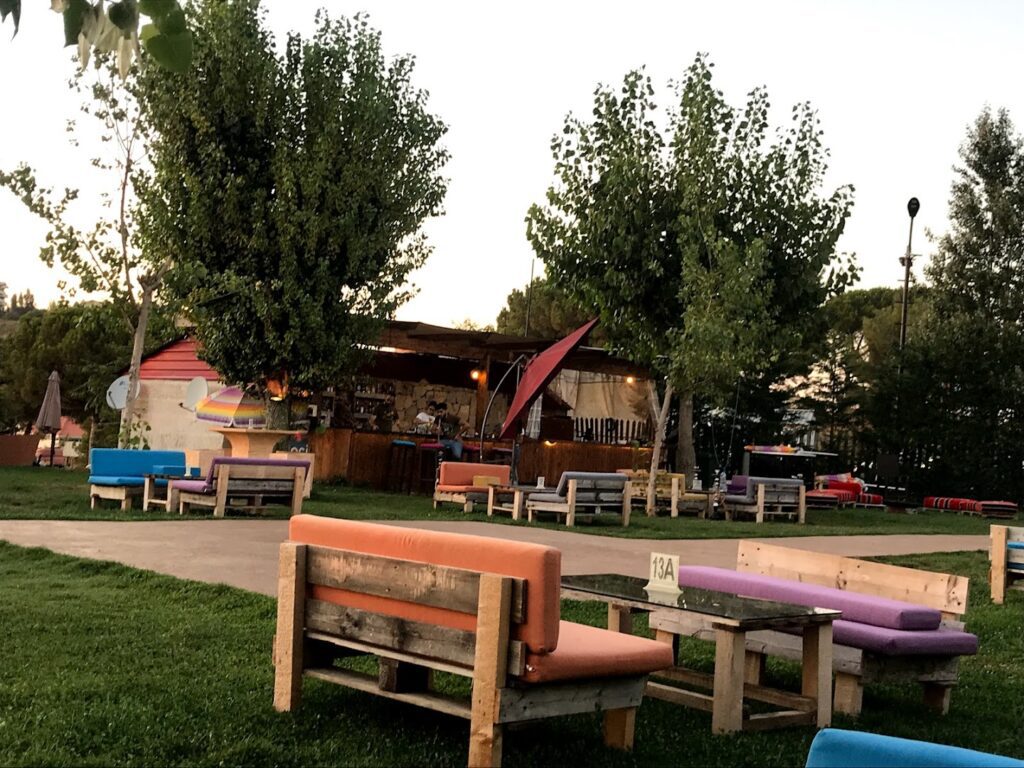 a group of benches and tables in a park