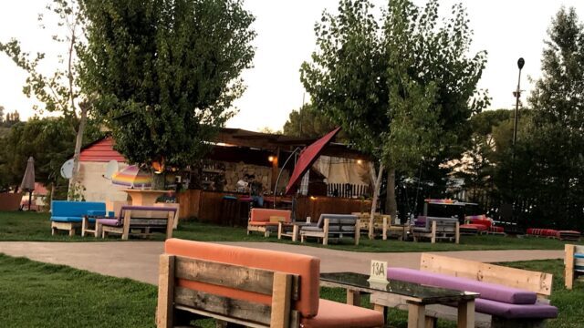 a group of benches and tables in a park