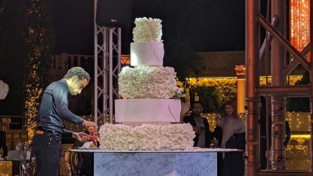 a man cutting a cake