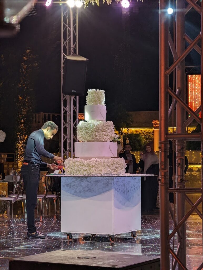a man cutting a cake