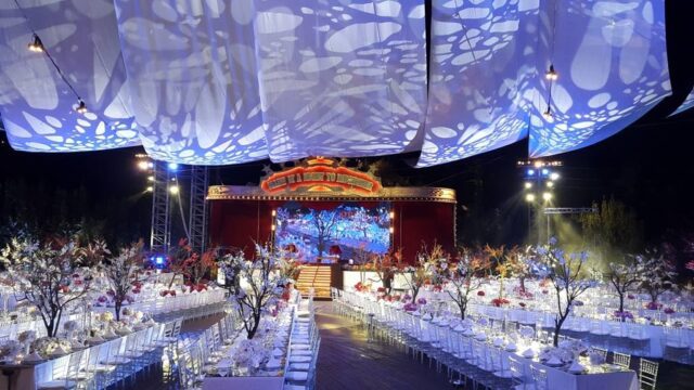 a large stage with tables and chairs