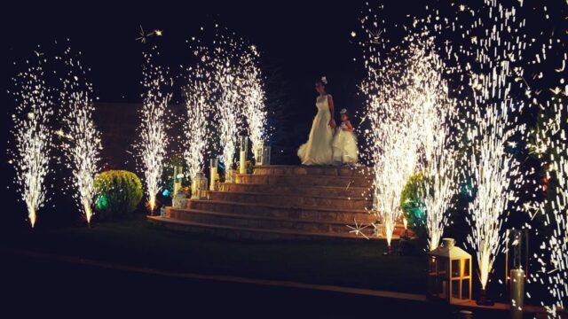 a woman and child standing on a staircase with fireworks