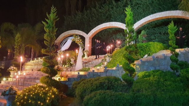 a group of people standing on a stone staircase with lights