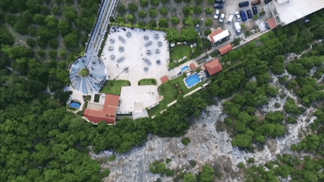 an aerial view of a building and trees