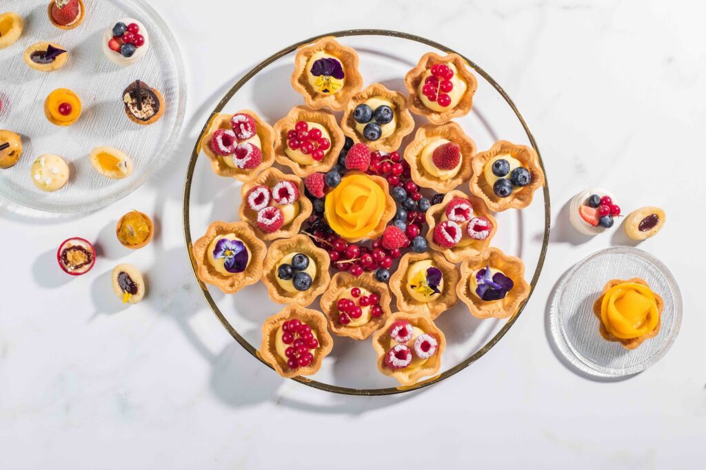 Le43 Catering served a plate of desserts with fresh fruit on it.