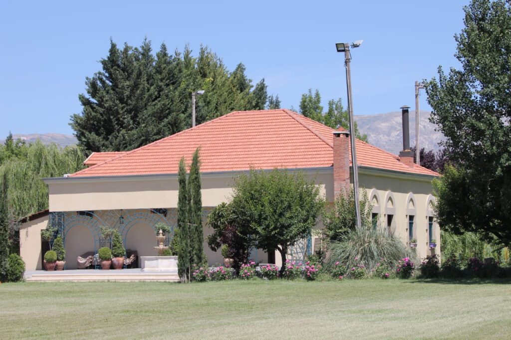 a building with a red roof and trees