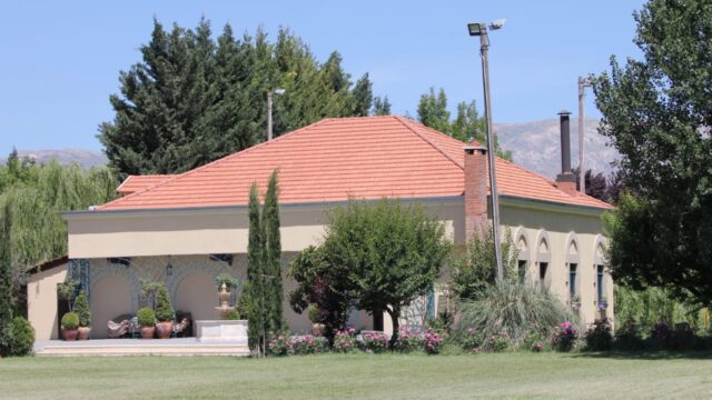 a building with a red roof and trees