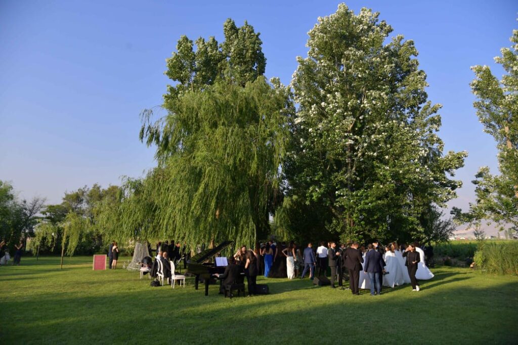 a group of people in formal attire outside