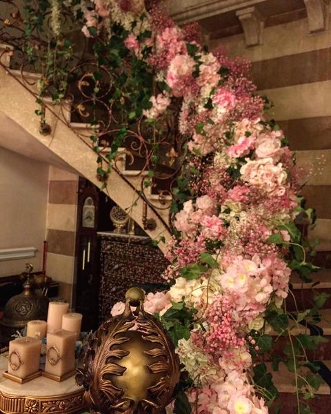 a spiral staircase with flowers and candles