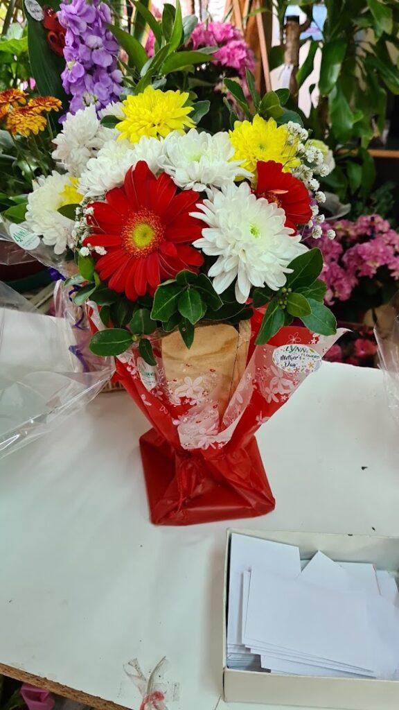 a bouquet of flowers in a red wrapper
