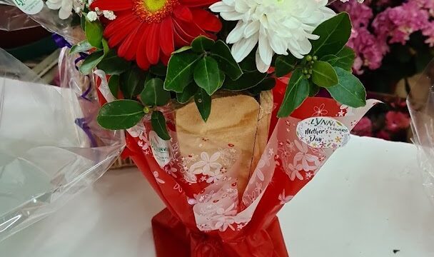 a bouquet of flowers in a red wrapper