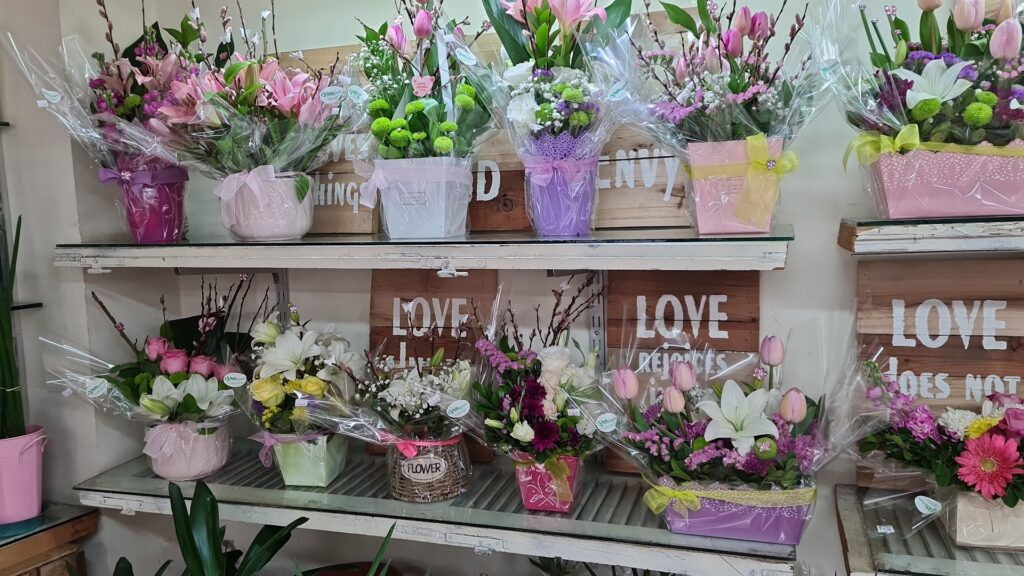 a shelf with flowers on it