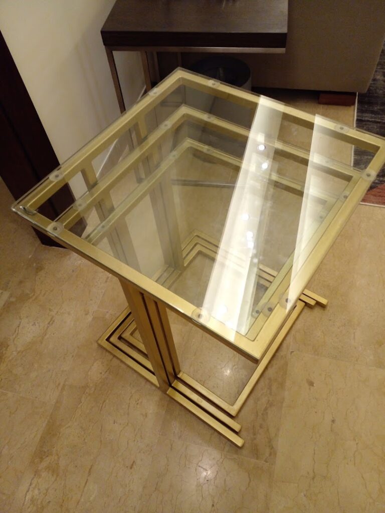 a glass table on a marble floor