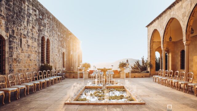 a courtyard with chairs and a fountain